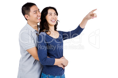 Happy couple with woman pointing up