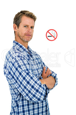 Portrait of serious man with no smoking sign