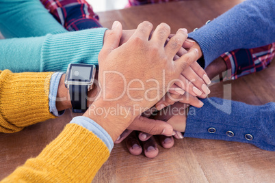 Business team with stacked hands on desk