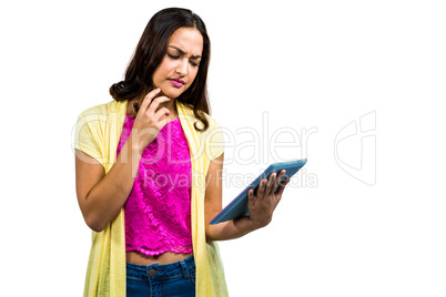 Confused woman using digital tablet