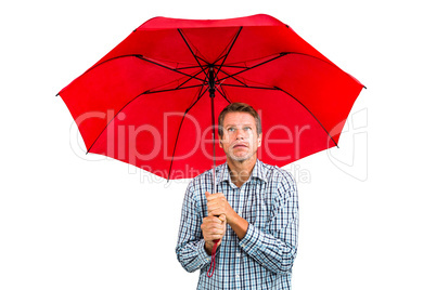 Scared man looking up while holding red umbrella