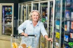 Smiling senior woman buying food