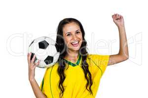 Stylish supporting woman holding football ball rejoicing