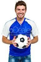 Portrait of happy man holding football