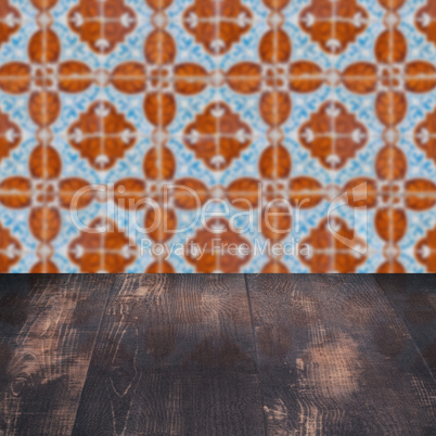 Wood table top and blur vintage ceramic tile pattern wall