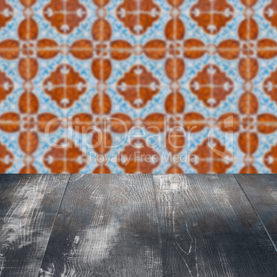 Wood table top and blur vintage ceramic tile pattern wall