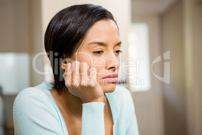 Upset brunette with hand on chin