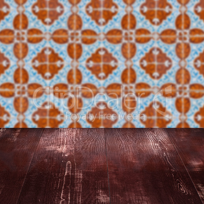 Wood table top and blur vintage ceramic tile pattern wall