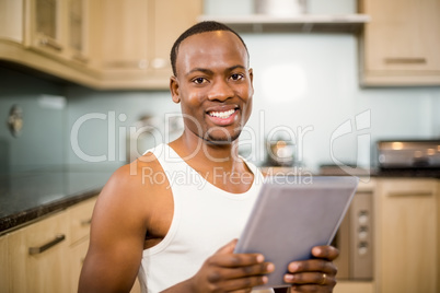 Smiling man holding tablet