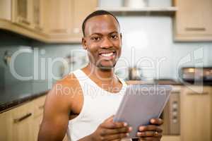 Smiling man holding tablet