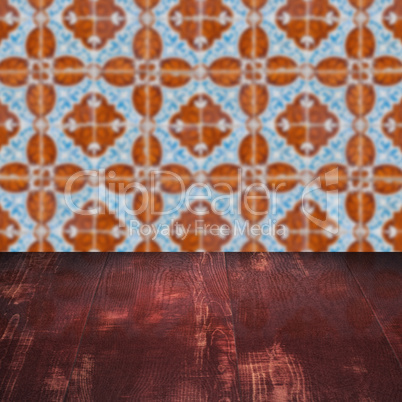 Wood table top and blur vintage ceramic tile pattern wall