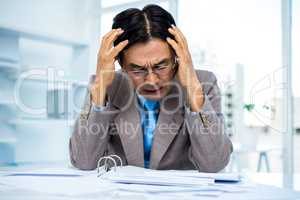 Worried businessman working at his desk