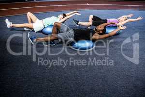 Fit people doing exercise with bosu ball