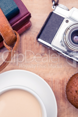 Overhead view of old camera with diaries and coffee