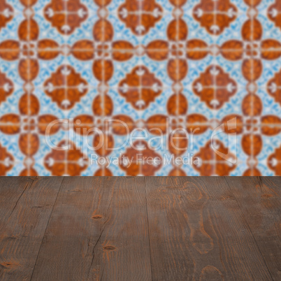 Wood table top and blur vintage ceramic tile pattern wall