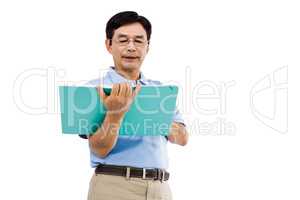 Elderly man holding a green folder