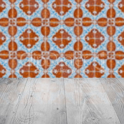 Wood table top and blur vintage ceramic tile pattern wall