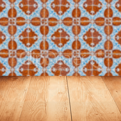 Wood table top and blur vintage ceramic tile pattern wall