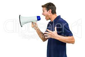 Side view of angry man shouting through megaphone