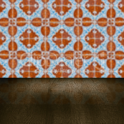 Wood table top and blur vintage ceramic tile pattern wall