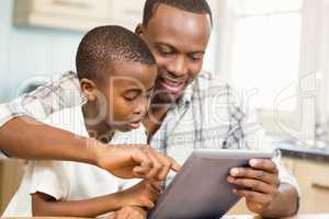 Father and son using tablet together