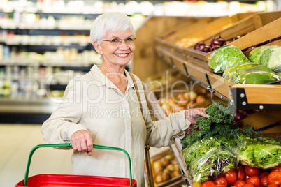 Senior woman picking out some vegetables