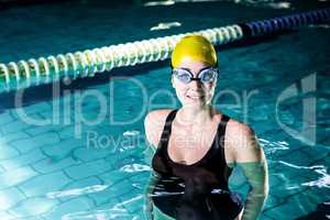 Fit smiling swimmer woman standing