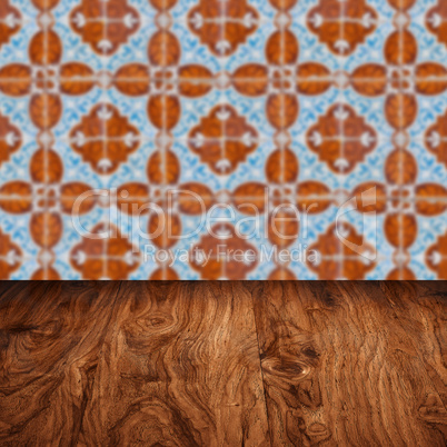 Wood table top and blur vintage ceramic tile pattern wall