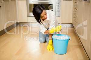 Attractive brunette cleaning the floor