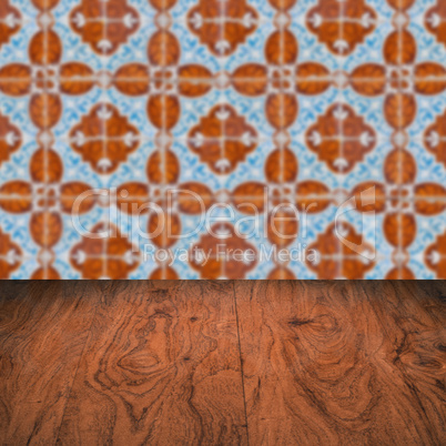 Wood table top and blur vintage ceramic tile pattern wall