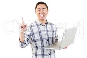 Happy man holding laptop and pointing