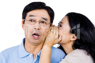 Woman whispering into partners ear