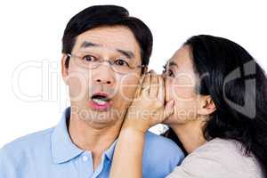 Woman whispering into partners ear