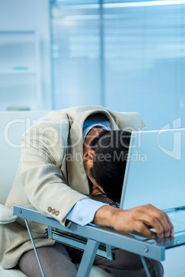 Tired asian businessman sleeping