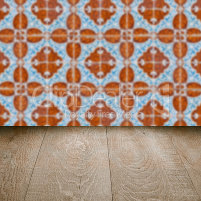 Wood table top and blur vintage ceramic tile pattern wall