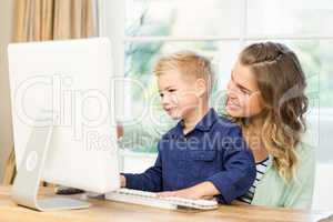 Mother and son using the computer
