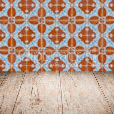 Wood table top and blur vintage ceramic tile pattern wall