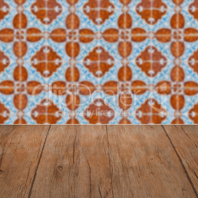 Wood table top and blur vintage ceramic tile pattern wall