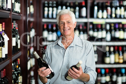 Smiling senior man choosing wine