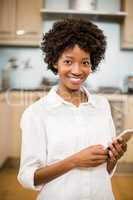 Smiling woman using table smartphone