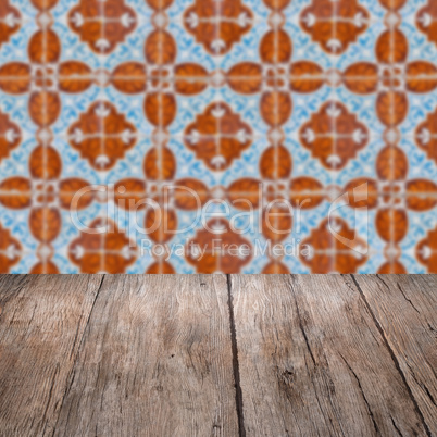 Wood table top and blur vintage ceramic tile pattern wall