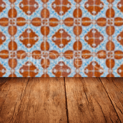 Wood table top and blur vintage ceramic tile pattern wall