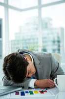 Asian businessman sleeping on his desk