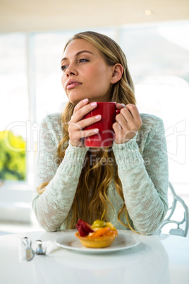 blonde drinking a coffee