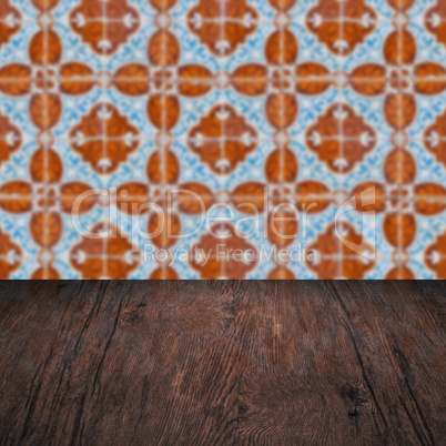 Wood table top and blur vintage ceramic tile pattern wall