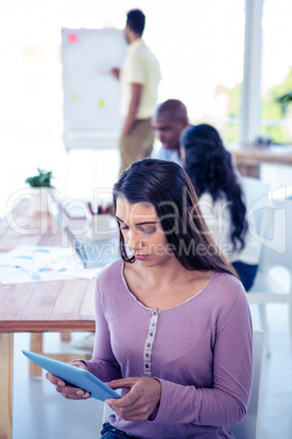 High angle view of businesswoman using tablet PC in conference r