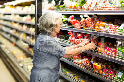 Senior woman picking out some vegetables