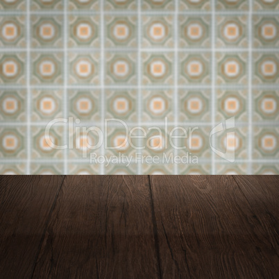 Wood table top and blur vintage ceramic tile pattern wall