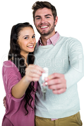 Stylish couple holding keys