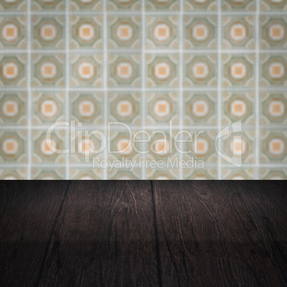 Wood table top and blur vintage ceramic tile pattern wall